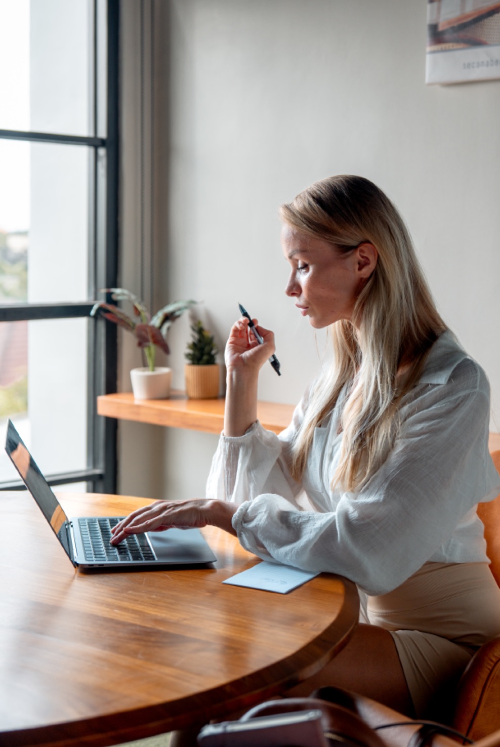 A member working on a laptop at Saya Work coworking